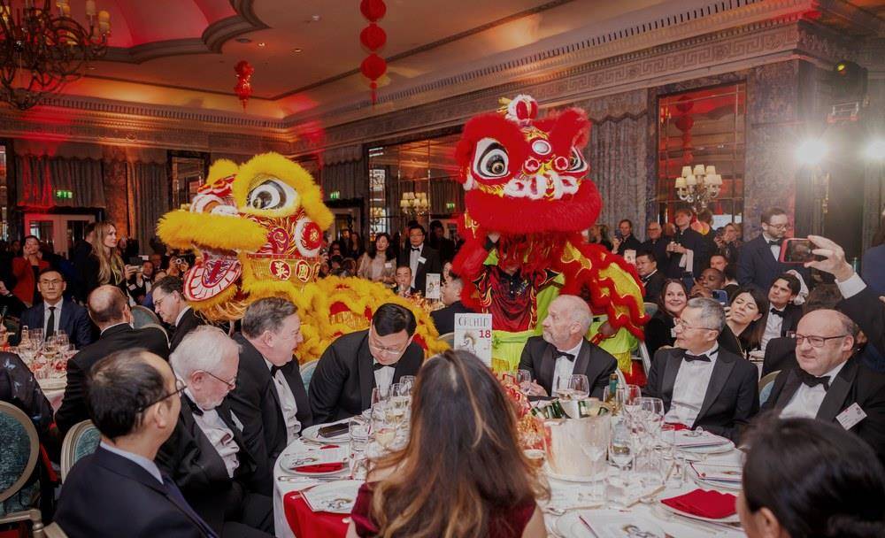 Lion dancers moving between tables in the ballroom