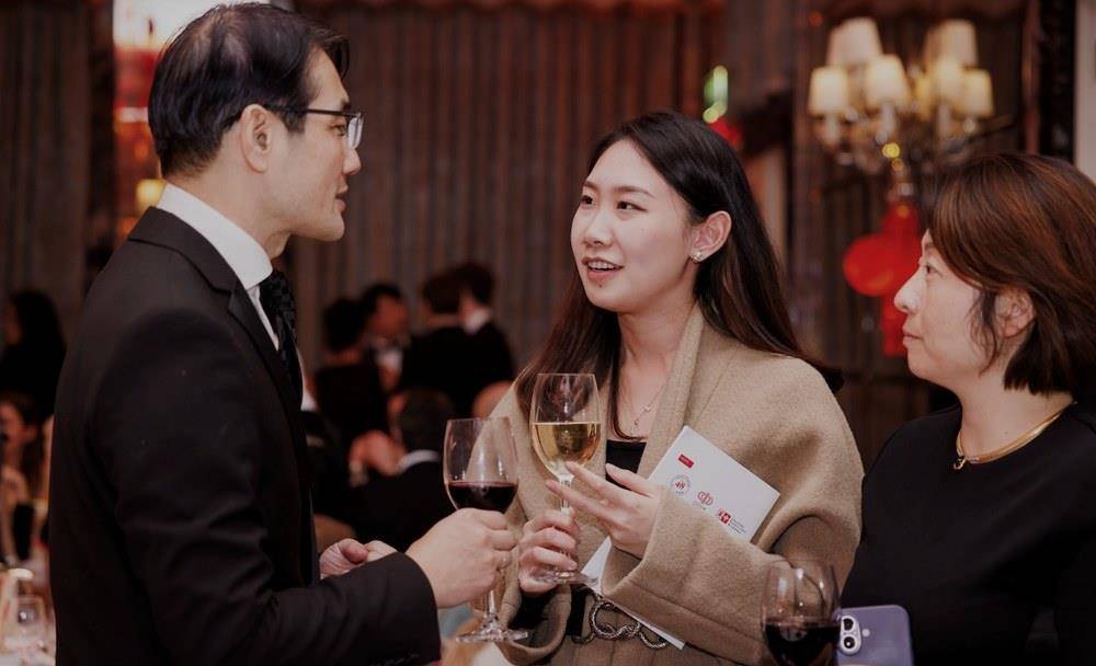 Guests talking over drinks at the reception