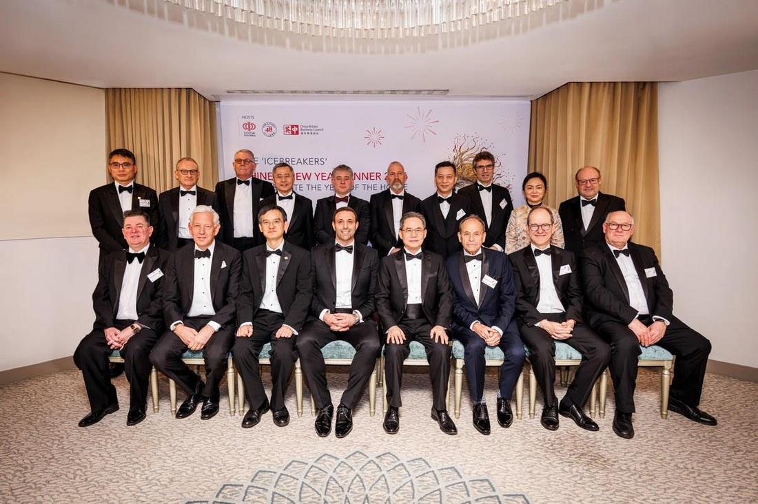 Hosts and guests in black tie gathered for a group photograph at the 2026 dinner